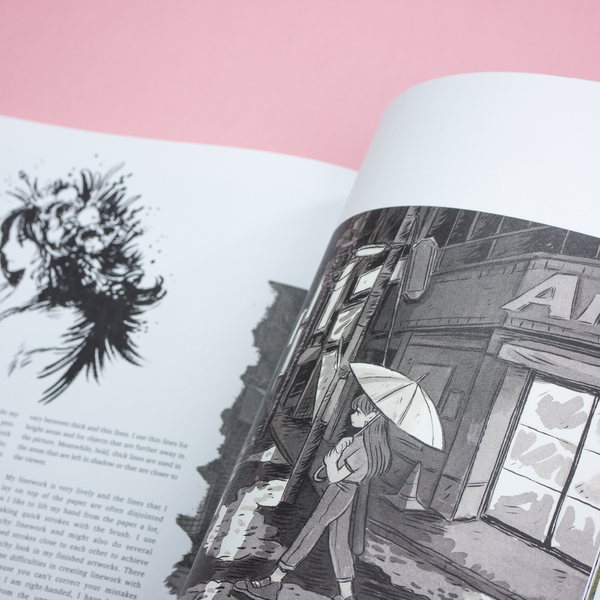 A closeup photo of a spread in The Art of Heikala art book, including text and images of ink illustrations.