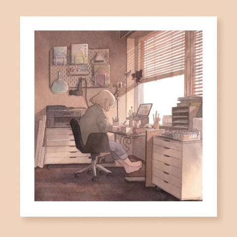 Print of a colored ink artwork depicting an artist sitting at their desk before a window, drawing. There are painting supplies and a laptop in front of them on the table, and a scanner and other art supplies behind them. A camera is suspended above their desk. The artist is barefoot and looks relaxed while they work in the room warmly lit by daylight streaming in through the window.